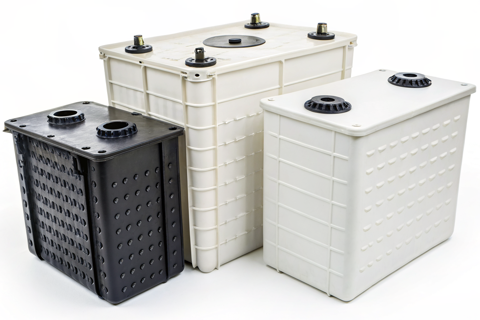 Three floor-mounted grease traps in different size tiers.