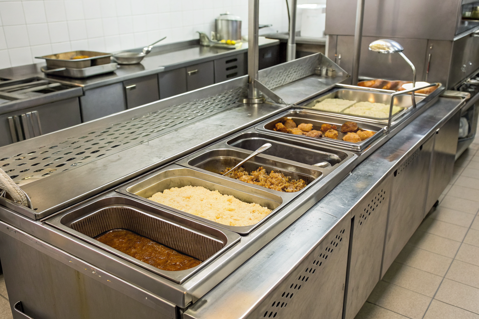 Kitchen with various grease trap units labeled by capacity.